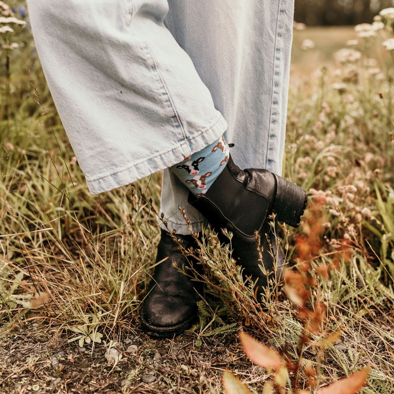 Cow Crew Socks featuring a soft light blue base with a cheerful cow face.