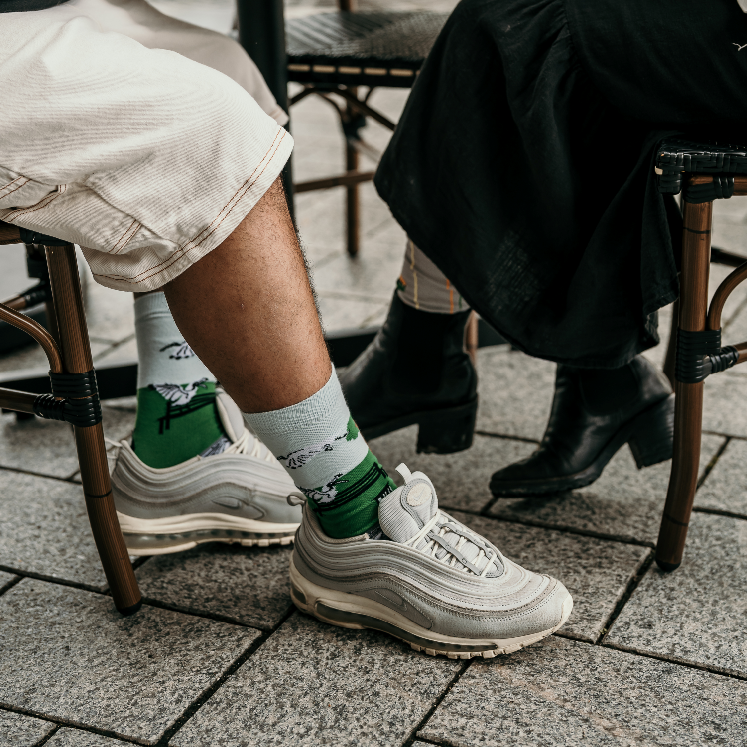 Ibis Crew Socks featuring a playful design inspired by Australian ibis in a park setting.