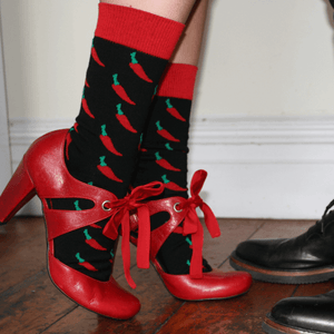 woman wearing chilli crew socks. Red cotton socks with chilli pattern