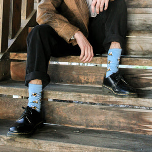 Person wearing Bumble Bee Crew Socks in light blue cotton