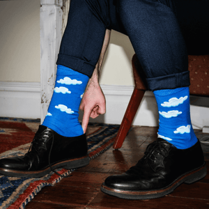 man wearing blue cloud crew socks with business shoes
