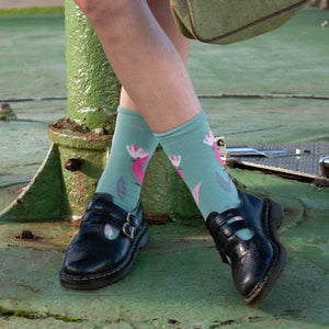 Person wearing Pink Galah Crew Socks in mint green and pink cotton
