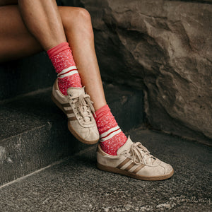 Person wearing Raspberry Lamington Crew Socks in pink cotton