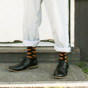 Person wearing Prawn Crew Socks in black, orange and yellow cotton